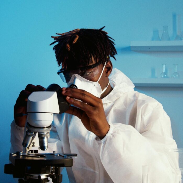 A man looking through the microscope